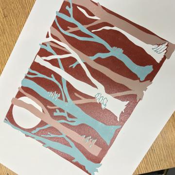 A linocut artwork of trees, in blue, red and white.